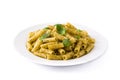 Penne pasta with pesto sauce and basil on a plate isolated Royalty Free Stock Photo