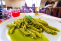 Penne pasta with pesto sauce on the plate, italian food