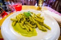 Penne pasta with pesto sauce on the plate, italian food