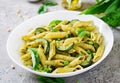 Penne pasta with pesto sauce, zucchini, green peas and basil. Royalty Free Stock Photo