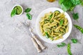 Penne pasta with pesto sauce, zucchini, green peas and basil. Royalty Free Stock Photo