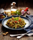 Penne pasta with spinach, sun dried tomatoes and chicken, sprinkled with parmesan cheese and fresh parsley  on a ceramic plate Royalty Free Stock Photo