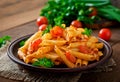 Penne pasta in tomato sauce with chicken, tomatoes decorated with parsley Royalty Free Stock Photo