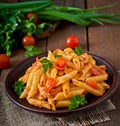 Penne pasta in tomato sauce with chicken, tomatoes decorated with parsley Royalty Free Stock Photo