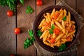 Penne pasta in tomato sauce with chicken, tomatoes decorated with parsley Royalty Free Stock Photo