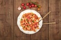 Penne pasta with tomato sauce, fork and spoon plunged into plate