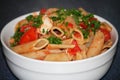 Closeup photo with isolated plate with penne pasta with tomatoes and chicken, homemade meal for lunch