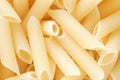 Penne rigate dry raw pasta background or texture. Organic food