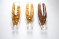 Penne rigate, egg pasta and buckwheat stored in glass bottles