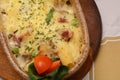 Baked pasta whit pork and cheese in ceramic pot