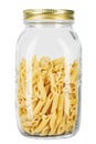 Pennette rigate. Raw pasta in a glass jar for storing bulk products. isolated on white background Royalty Free Stock Photo