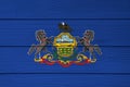 Pennsylvania flag color painted on Fiber cement sheet wall background. Coat of arms of Pennsylvania on blue field
