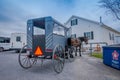 Pennsylvania, USA, APRIL, 18, 2018: View of the back of Amish buggy with a horse parked in a farm