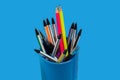 pens and pencils lying in a blue penholder Royalty Free Stock Photo