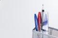 Pens and pencils in a wire mesh desk tidy Royalty Free Stock Photo