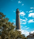 Pensacola Lighthouse in Florida on a partly cloudy day.