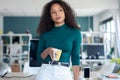 Pensative young woman looking outside while holding a cup of coffee in the office Royalty Free Stock Photo