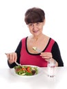 Pension age good looking smiling woman eating green salad Royalty Free Stock Photo