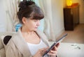 Pension age good looking woman searching in internet on tablet device Royalty Free Stock Photo