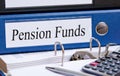 Pension Funds - blue binder with text in the office