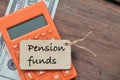 PENSION FUNDS written on wooden tag over wooden background Royalty Free Stock Photo