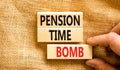 Pension time bomb symbol. Concept words Pension time bomb on wooden blocks on a beautiful canvas table canvas background.