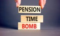 Pension time bomb symbol. Concept words Pension time bomb on wooden blocks on a beautiful grey table grey background. Businessman