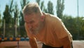 Pensioner breathing heavily after training physical activity elderly man dyspnea sporty athlete sportsman recreation Royalty Free Stock Photo