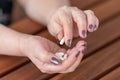 an elderly woman holds a handful of medicine capsules in her hands. horizontal photo Royalty Free Stock Photo