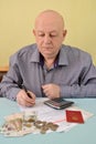 The pensioner counts cash expenditures on utility payments Royalty Free Stock Photo