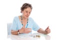 Pensioner counts her income - elder woman isolated on white back