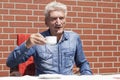 Pensioner drinking coffee
