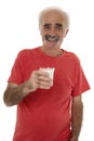 Pensioner holding glass of milk