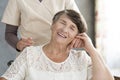 Pensioner holding hand of nurse