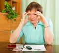 Pensioner looking at bills and counting money Royalty Free Stock Photo