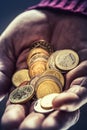 Pensioner man holding in hands euro coins. Theme of low pensions