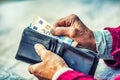 Pensioner man holding in hands wallet with money Royalty Free Stock Photo