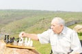 Pensioner playing chess outdoors Royalty Free Stock Photo