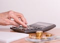 A pensioner sums up his money on a calculator. Hand of an old woman and a calculator close-up Royalty Free Stock Photo