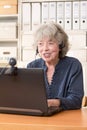 Pensioner telephoning via skype Royalty Free Stock Photo