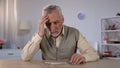 Pensioner trying to combine puzzle, having memory problems, cognitive impairment Royalty Free Stock Photo