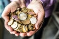 Pensioner woman holding in hands euro coins. Theme of low pensions