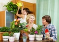 Pensioners and girl caring for decorative plants