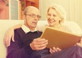 Pensioners watching old photoes Royalty Free Stock Photo