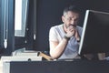 Pensive adult man is sitting at his desk Royalty Free Stock Photo