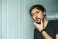 Pensive adult unshaven man with hand on chin Royalty Free Stock Photo