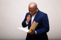Pensive African American Businessman Looks Through Folder