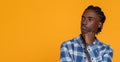 Pensive African American Guy Looking Aside At Copy Space And Touching Chin Royalty Free Stock Photo