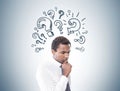 Pensive African American man, question marks Royalty Free Stock Photo
