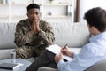 Pensive african american soldier attending psychotherapist at clinic Royalty Free Stock Photo